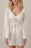 White resort wear cover-up with lace fabric.