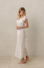 Women's white beachwear with lace fabrics and ruffles.
