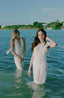 White swimsuit cover-up with ruffle sleeve.