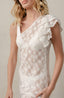 White swimsuit cover with ruffle details and one shoulder.